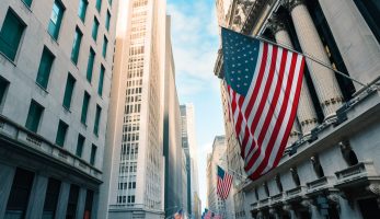 Wall Street in New York. American flag on Building of New York